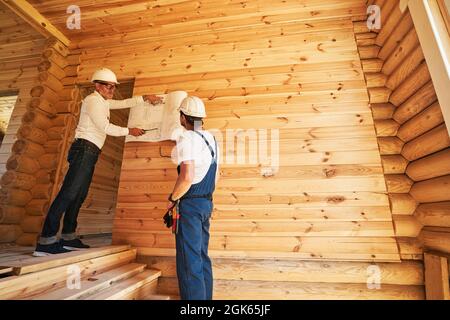 Construction engineer explaining plan of action to worker Stock Photo