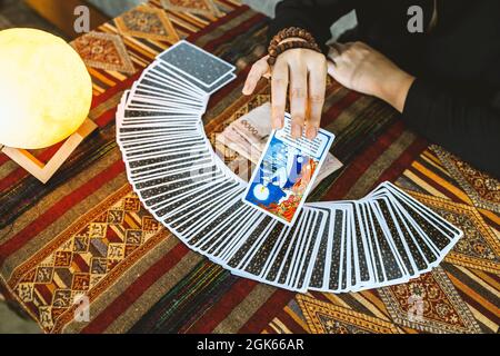 fortune teller using tarot cards and thai money on table background Stock Photo