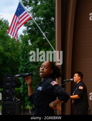 Senior Airman MeLan Smartt and Airman 1st Class Christopher Arellano, along with the rest of the band, perform “Proud Mary,” a song made famous by Tina Turner, during a concert by Flight One at Centerville Community Amphitheater in Stubbs Park, Centerville, Ohio, on Aug. 13, 2021. Stock Photo