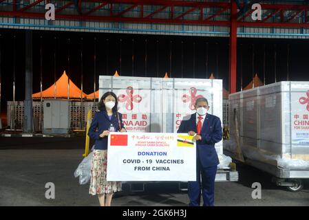 Bandar Seri Begawan, Brunei. 12th Sep, 2021. Yu Hong (L), Chinese ambassador to Brunei, and Haji Erywan, Brunei's second minister of foreign affairs, attend the handover ceremony of Sinopharm COVID-19 vaccines at Brunei International Airport, Brunei, Sept. 12, 2021. A total of 100,000 doses of Sinopharm vaccine contributed by the Chinese government to Brunei arrived at Brunei International Airport on Sunday midnight. Credit: Xue Fei/Xinhua/Alamy Live News Stock Photo