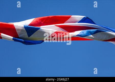 United Kingdom British flag flying in the wind with a blue sky background and copy space Stock Photo
