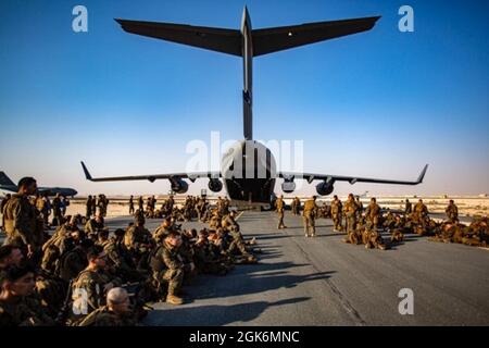 Marines assigned to the 24th Marine Expeditionary Unit (MEU) await a flight at Al Udeied Air Base, Qatar August 17. Marines are assisting the Department of State with an orderly drawdown of designated personnel in Afghanistan. Stock Photo