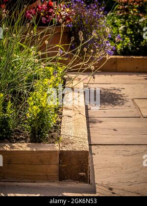 Wooden raised flower beds in a UK garden. Stock Photo