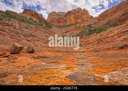 The north cliff face of Cathedral Rock in Sedona viewed from a sandstone wash that intersects the Templeton Trail. Stock Photo