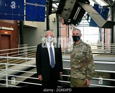 Secretary of the Air Force Frank Kendall stands with Lt. Gen. Stephen Whiting, Space Operations Command Commander, in front of a Space-Based Infrared System (SBIRS) model at Peterson Space Force Base, Colorado, August 18, 2021. During his first visit to Peterson SFB, Kendall met with U.S. Space Command, U.S. Northern Command and SpOC leadership, as well as Airmen and Guardians to recognize their roles in protecting the nation. Stock Photo