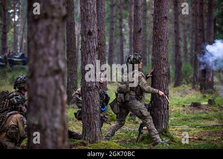 Danish Soldiers within Danish army's 2nd Armored Infantry Battalion, conduct live-fire exercise Wild Leopard Aug. 19 2021, at Grafenwoehr Training Area, Germany. The purpose of the exercise is to train platoon and company sized infantry forces together in wooded and urban terrain. Stock Photo