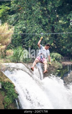 PULHAPANZAK, HONDURAS - APRIL 18, 2016: Tourist is canopying over Pulhapanzak waterfall Stock Photo