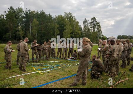 Danish Soldiers within Danish army's 2nd Armored Infantry Battalion, brief the live-fire exercise Wild Leopard to participants Aug. 20 2021, at Grafenwoehr Training Area, Germany. The purpose of the exercise is to train platoon and company sized infantry forces together in wooded and urban terrain. Stock Photo