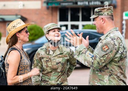U.S. Air Force Col. Patrick Miller, 88th Air Base Wing and Wright-Patterson Air Force Base, Ohio, commander, right, talks with Airman 1st Class Paige Eaglestone, with the 88th Medical Group, and a member of her family, outside Day Air Credit Union Ballpark as part of the Dayton Dragons Hometown Heroes Night events, Aug. 21, 2021, in Dayton. During the night, fans were able to look at hands-on displays from the base, as well witness members of the military throw out the ceremonial first pitch, sing the national anthem and presented the colors during the pregame ceremonies. Stock Photo