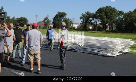 Department of Public Works and Morale Welfare and Recreation personnel prepare a temporary soccer field to be used by Afghans on Fort McCoy, Wisconsin, Aug. 22, 2021. The Department of Defense, through U.S. Northern Command, and in support of the Department of State and Department of Homeland Security, is providing transportation, temporary housing, medical screening, and general support for up to 50,000 Afghan evacuees at suitable facilities, in permanent or temporary structures, as quickly as possible. This initiative provides vulnerable Afghans essential support at secure locations outside Stock Photo