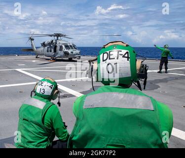 210822-N-WU807-1028 PHILIPPINE SEA (Aug. 22, 2021) Sailors stand by for flight operations for an MH-60S Sea Hawk helicopter attached to Helicopter Sea Combat Squadron (HSC) 21 assigned to Independence-variant littoral combat ship USS Charleston (LCS 18), Aug. 22. Charleston, part of Destroyer Squadron Seven, is on a rotational deployment, operating in the U.S. 7th fleet area of operations to enhance interoperability with partners and serve as a ready-response force in support of a free and open Indo-Pacific region. Stock Photo