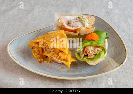 Mixed tray of delicious Spanish tapas on gray linen tablecloth Stock Photo