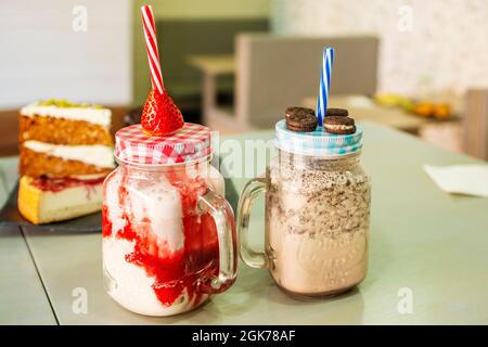 Chocolate milkshake with cookies and strawberry milkshake with strawberries Stock Photo