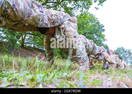 Pfc. Gregory Roberts, an infantryman with Alpha Company, 2nd Battalion, 34th Armored Regiment, 1st Armored Brigade Combat Team, 1st Infantry Division, participates in sniper pushups during sniper selection at Drawsko Pomorskie Training Area, Poland, August 23, 2021. As part of the five-day sniper selection, candidates conducted a series of team calisthenics on day one. Stock Photo