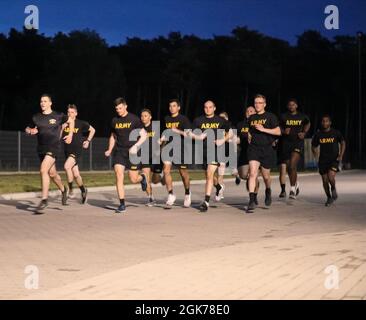 Soldiers with 2nd Battalion, 34th Armored Regiment, 1st Armored Brigade Combat Team, 1st Infantry Division begin the four-mile run event as part of sniper selection at Drawsko Pomorskie Training Area, Poland, August 23, 2021. Candidates must successfully complete 49 pushups and 59 situps within two minutes, followed by a four-mile run under 32 minutes. Stock Photo