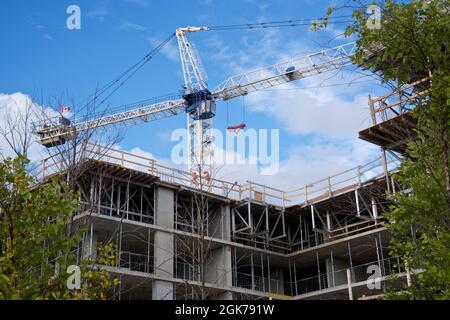 Crane and building construction site against the blue sky Stock Photo