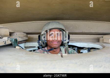 Pfc. Daryl Henderson, an M1 armor crewman with Alpha Company, 2nd Battalion “Orphans,” 34th Armored Regiment, 1st Armored Brigade Combat Team, 1st Infantry Division, pauses for a photo at Drawsko Pomorskie Training Area, Poland, August 23, 2021. The persistent presence of armored and mechanized infantry units across Central and Eastern Europe sends a powerful message of commitment and reassurance. Stock Photo