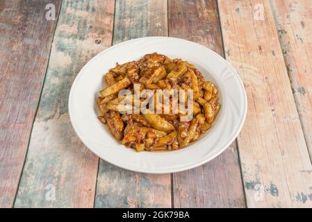 Chinese stew of chopped aubergines with spicy meat on white porcelain plate Stock Photo