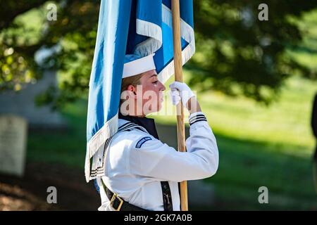 A personal color bearer from the U.S. Navy Honor Guard carryies the Secretary of State flag curing a joint full military honors funeral service for former U.S. Secretary of Defense Donald H. Rumsfeld in Section 34 of Arlington National Cemetery, Arlington, Virginia, August 23, 2021.    Rumsfeld was Secretary of Defense for Presidents Gerald R. Ford and George W. Bush, as well as a three-term U.S. Congressman from Illinois (1963-1969), director of the Office of Economic Opportunity (1969-1970), U.S Representative to NATO (1973-1974) and the White House Chief of Staff under President Gerald Ford Stock Photo