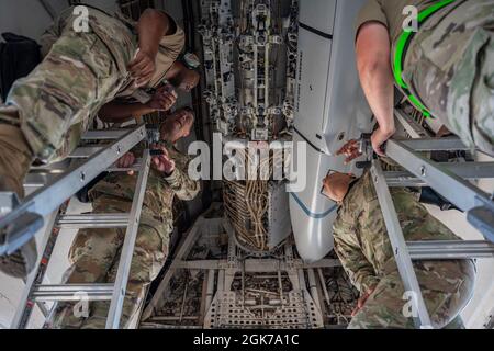 Maj. Gen. Andrew Gebara, 8th Air Force and Joint-Global Strike Operations Center commander, center left, and Chief Master Sgt. Melvina Smith, 8th AF command chief, center right, watch as Airmen assigned to the 7th Aircraft Maintenance Squadron load inert munitions into a B-1B Lancer during a weapons load exercise at Dyess Air Force Base, Texas, Aug. 23, 2021. The B-1 is a long-range strategic bomber capable of delivering precision and non-precision munitions to any location around the globe. Stock Photo