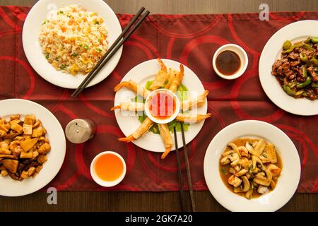 Top view image of set of popular Chinese food dishes, gabardine prawns, spicy prawns, beef with peppers and rice three delicacies. Stock Photo