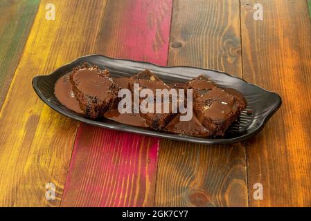 Tray of brownie cake with milk chocolate syrup in quantity Stock Photo