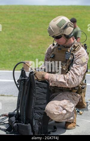 A U.S. Marine with 4th Platoon, Force Reconnaissance Company, III Marine Expeditionary Force, prepares an assault breacher’s kit during mechanical and thermal breaching training on Camp Hansen, Okinawa, Japan, Aug. 25, 2021. This training taught Marines proper techniques for breaching steel plates using different tools which enables them to be more proficient in the field. Stock Photo