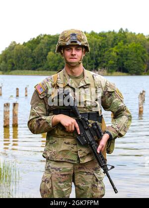 Pfc. Andrew Shaw, a cavalry scout with Headquarters and Headquarters Company “Hoplites,” 2nd Battalion, 34th Armored Regiment, 1st Armored Brigade Combat Team, 1st Infantry Division, stands by for a photo during 2-34’s sniper selection at Drawsko Pomorskie Training Area, Poland, Aug. 25, 2021. Shaw was one of four selected out of eleven candidates who participated. Stock Photo