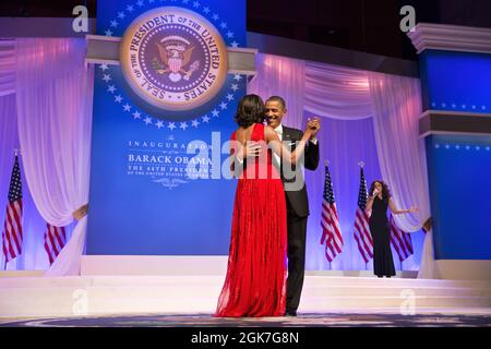 President Barack Obama and First Lady Michelle Obama dance at the Commander in Chief Ball at the Walter E. Washington Convention Center in Washington, D.C., Jan. 21, 2013. The President and First Lady danced to  'Let's Stay Together' performed by Jennifer Hudson, right. (Official White House Photo by Pete Souza) This official White House photograph is being made available only for publication by news organizations and/or for personal use printing by the subject(s) of the photograph. The photograph may not be manipulated in any way and may not be used in commercial or political materials, adver Stock Photo