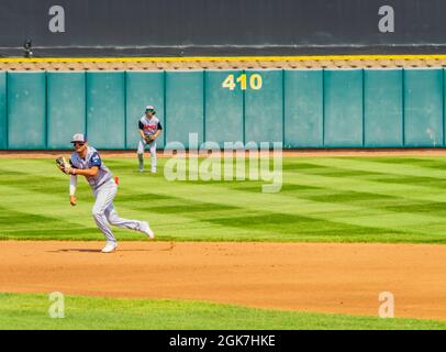 baseball players running to catch the ball Stock Photo