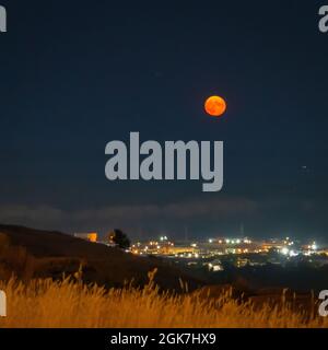full super moon rising over the lights of Billings , Montana Stock Photo