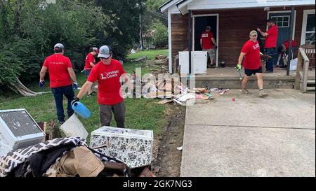 Waverly, TN (August 27, 2021) - Members of the volunteer group, Life Point Church, are removing flood debris from inside this damaged residence in Waverly, Tennessee. Robert Kaufmann/FEMA Stock Photo