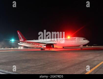 210829-N-OX321-1175 NAVAL AIR STATION SIGONELLA, Italy (Aug. 28, 2021) An Omni Air International Boeing 767-300ER aircraft with evacuees from Afghanistan departs Naval Air Station (NAS) Sigonella to the United States, Aug. 28, 2021. NAS Sigonella is currently supporting Department of State mission to facilitate the safe departure and relocation of U.S. citizens, Special Immigration Visa recipients, and vulnerable populations from Afghanistan. Stock Photo