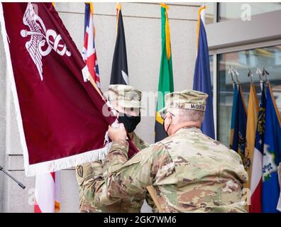 Brig Gen. Anthony McQueen, commanding general, U.S. Army Medical Research and Development Command and Fort Detrick, Md. passes the Walter Reed Army Institute of Research's unit colors to incoming commander Col. Chad Koenig during an assumption of command ceremony, Aug. 31, 2021, Silver Spring, Md. Stock Photo