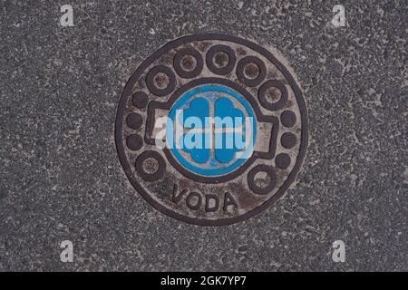 Manhole cover-up on a public asphalt city road in Pärnu, Estonia. Attention to detail. Stock Photo