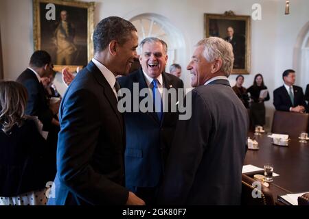 President Barack Obama greets Transportation Secretary Ray LaHood and Defense Secretary Chuck Hagel before a Cabinet meeting in the Cabinet Room of the White House, March 4, 2013. (Official White House Photo by Pete Souza) This official White House photograph is being made available only for publication by news organizations and/or for personal use printing by the subject(s) of the photograph. The photograph may not be manipulated in any way and may not be used in commercial or political materials, advertisements, emails, products, promotions that in any way suggests approval or endorsement of Stock Photo