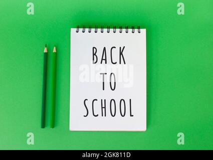 School supplies on bright green background with copyspace. Back to school concept. Stock Photo