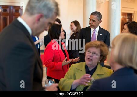 President Barack Obama talks with Senators Mazie Hirono, D-Hawaii, and Maria Cantwell, D-Wash., in the Grand Foyer of the White House prior to a dinner with a bipartisan group of women senators, April 23, 2013. Chief of Staff Denis McDonough talks with Senators Barbara Mikulski, D-Md., and Patty Murray, D-Wash., in the foreground. (Official White House Photo by Pete Souza)  This official White House photograph is being made available only for publication by news organizations and/or for personal use printing by the subject(s) of the photograph. The photograph may not be manipulated in any way Stock Photo