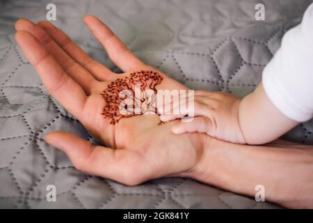 Parent and child hands and tree of life on the palm. Family generations and eternity concept Stock Photo