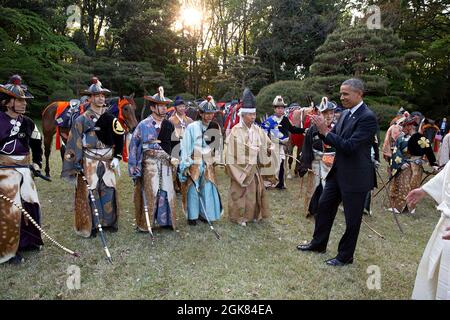 President Barack Obama applauds participants following an archery demonstration at the Meiji Shrine in Tokyo, Japan, April 24, 2014. (Official White House Photo by Pete Souza) This official White House photograph is being made available only for publication by news organizations and/or for personal use printing by the subject(s) of the photograph. The photograph may not be manipulated in any way and may not be used in commercial or political materials, advertisements, emails, products, promotions that in any way suggests approval or endorsement of the President, the First Family, or the White Stock Photo