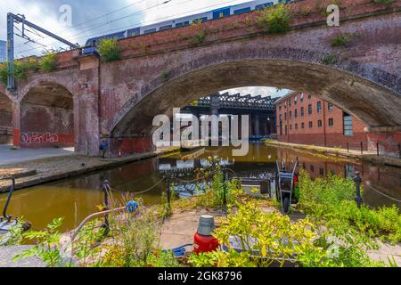 View of train crossing canals in Castlefield Basin, Manchester, England, United Kingdom, Europe Stock Photo
