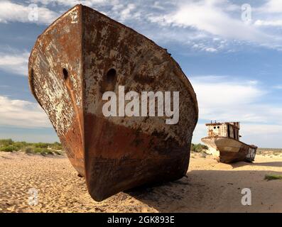 Boats in desert around Moynaq, Muynak or Moynoq - Aral sea or Aral lake - Uzbekistan - asia Stock Photo