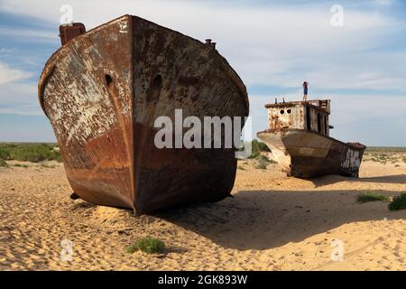 Boats in desert around Moynaq, Muynak or Moynoq - Aral sea or Aral lake - Uzbekistan - asia Stock Photo