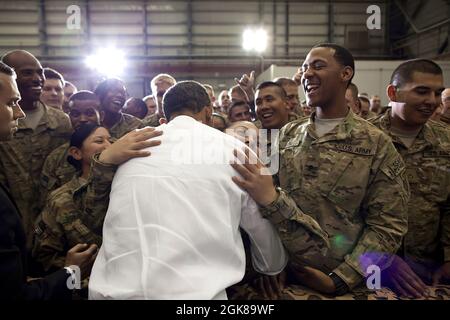 May 1, 2012'A soldier hugs the President as he greeted U.S. troops at Bagram Air Field in Afghanistan.'  (Official White House Photo by Pete Souza)  This official White House photograph is being made available only for publication by news organizations and/or for personal use printing by the subject(s) of the photograph. The photograph may not be manipulated in any way and may not be used in commercial or political materials, advertisements, emails, products, promotions that in any way suggests approval or endorsement of the President, the First Family, or the White House. Stock Photo
