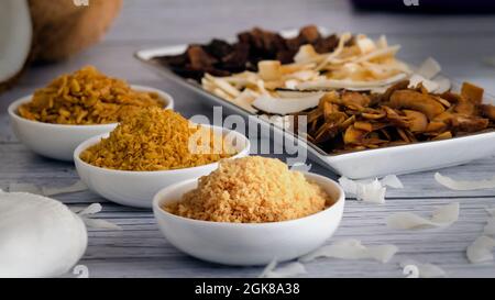 Tasty Crunchy Toasted Coconut Chips on White Bowls. Stock Photo