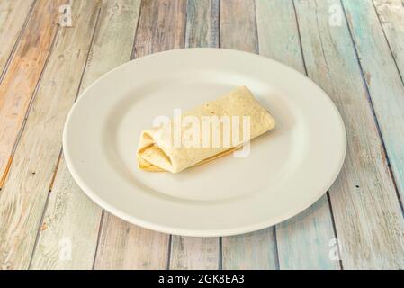 simple closed burrito of tortilla stuffed with wheat of whatever you want to imagine. Stock Photo