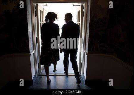 President Barack Obama and First Lady Michelle Obama hold hands as they walk from the Diplomatic Reception Room of the White House to Marine One for departure en route to Fort Hood, Texas, April 9, 2014. (Official White House Photo by Chuck Kennedy)  This official White House photograph is being made available only for publication by news organizations and/or for personal use printing by the subject(s) of the photograph. The photograph may not be manipulated in any way and may not be used in commercial or political materials, advertisements, emails, products, promotions that in any way suggest Stock Photo