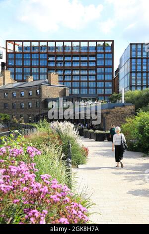 Walking on pretty Bagley Walk, with modern office blocks on Goods Way beyond, at Coal Drops Yard, at Kings Cross, north London, UK Stock Photo