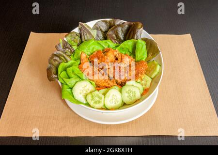 Mixed lettuce salad, fried pork rinds, grated carrots and sliced cucumbers Stock Photo