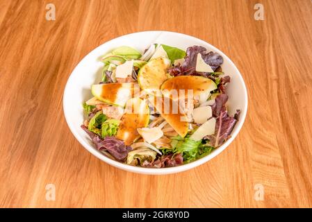 Sprout salad bowl with apple slices, white onion, canned tuna torozos and parmesan cheese flakes Stock Photo